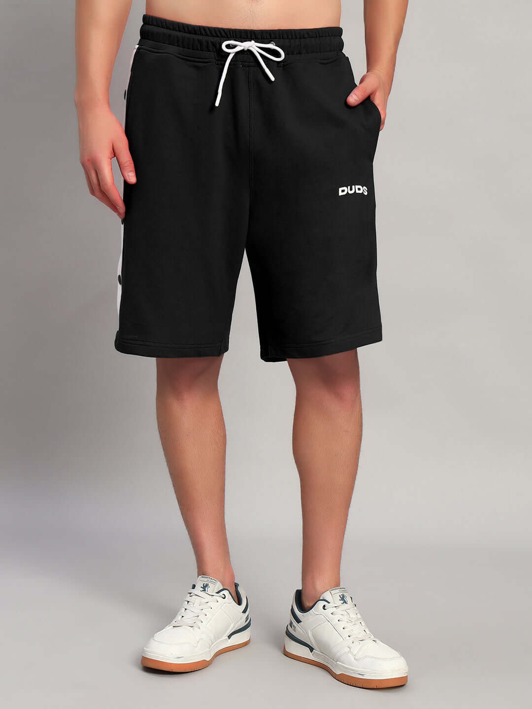 Person wearing Ezel Regular Fit Shorts Black Cotton by WEAR DUDS, showcasing modern streetwear style and comfort.