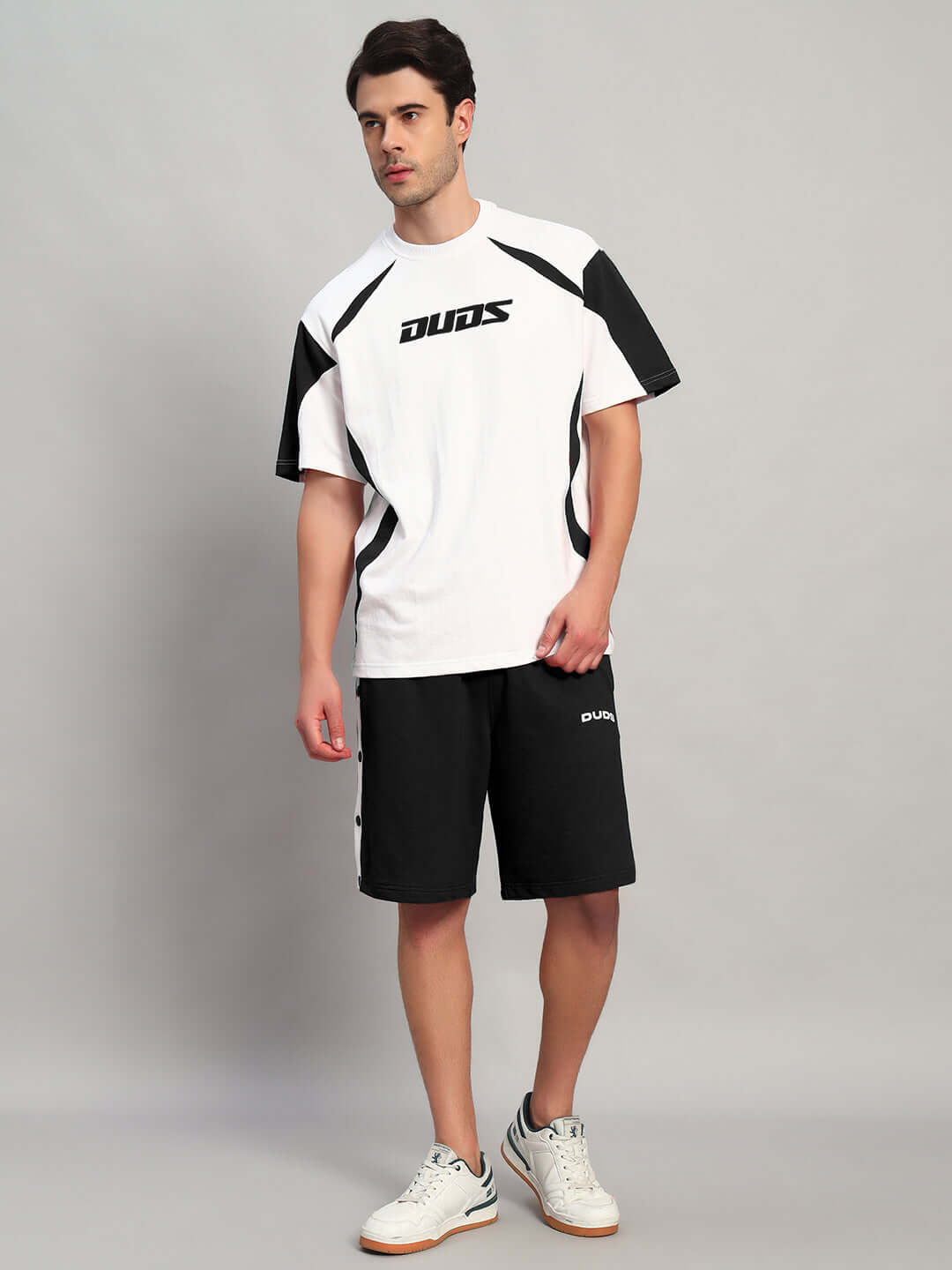 EZEL REGULAR FIT SHORTS BLACK worn by model with white DUDS t-shirt, showcasing casual streetwear style.