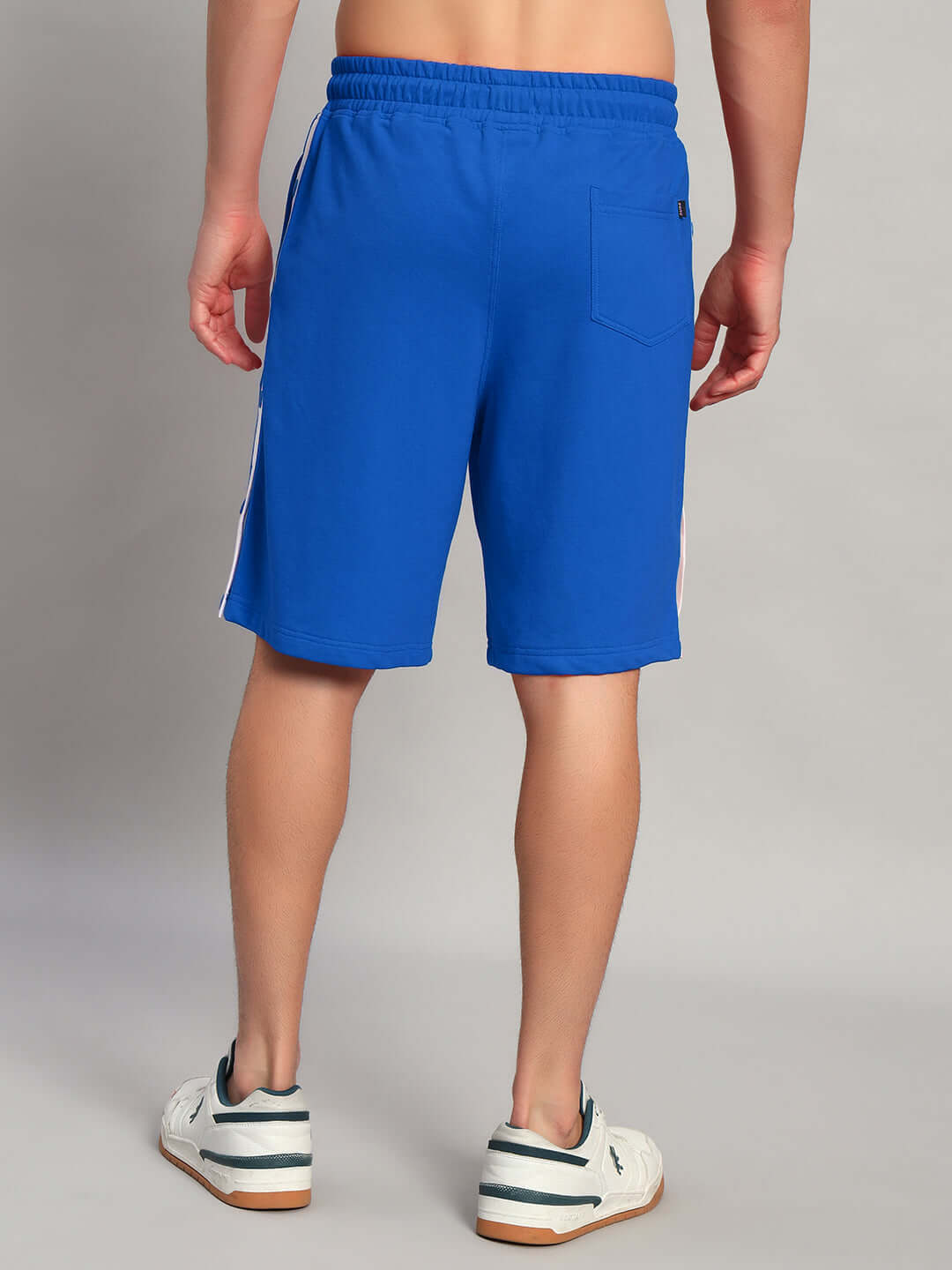 Back view of EZEL REGULAR FIT COTTON SHORTS BLUE on a person, showcasing the comfort and stylish design of these versatile shorts.