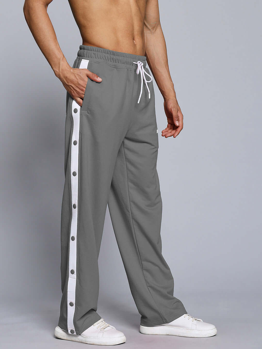 Men's grey joggers with a relaxed fit and white button-down side stripes, featuring an elastic waistband and drawstring.