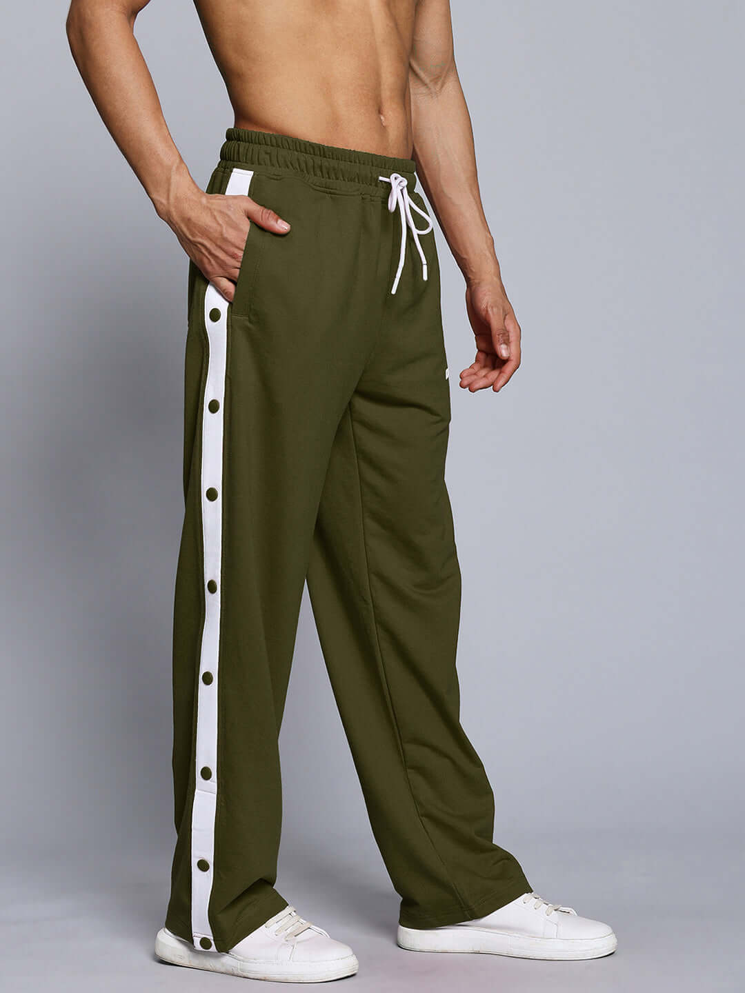 Man wearing EZEL RELAXED FIT JOGGER OLIVE GREEN with side stripe detailing, showcasing relaxed fit and style.