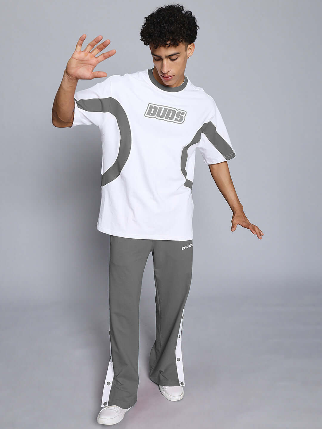 Man wearing EZEL RELAXED FIT CO-ORD SET WHITE-GREY with contrast panel joggers, showcasing unisex relaxed fit with elasticated waistband.