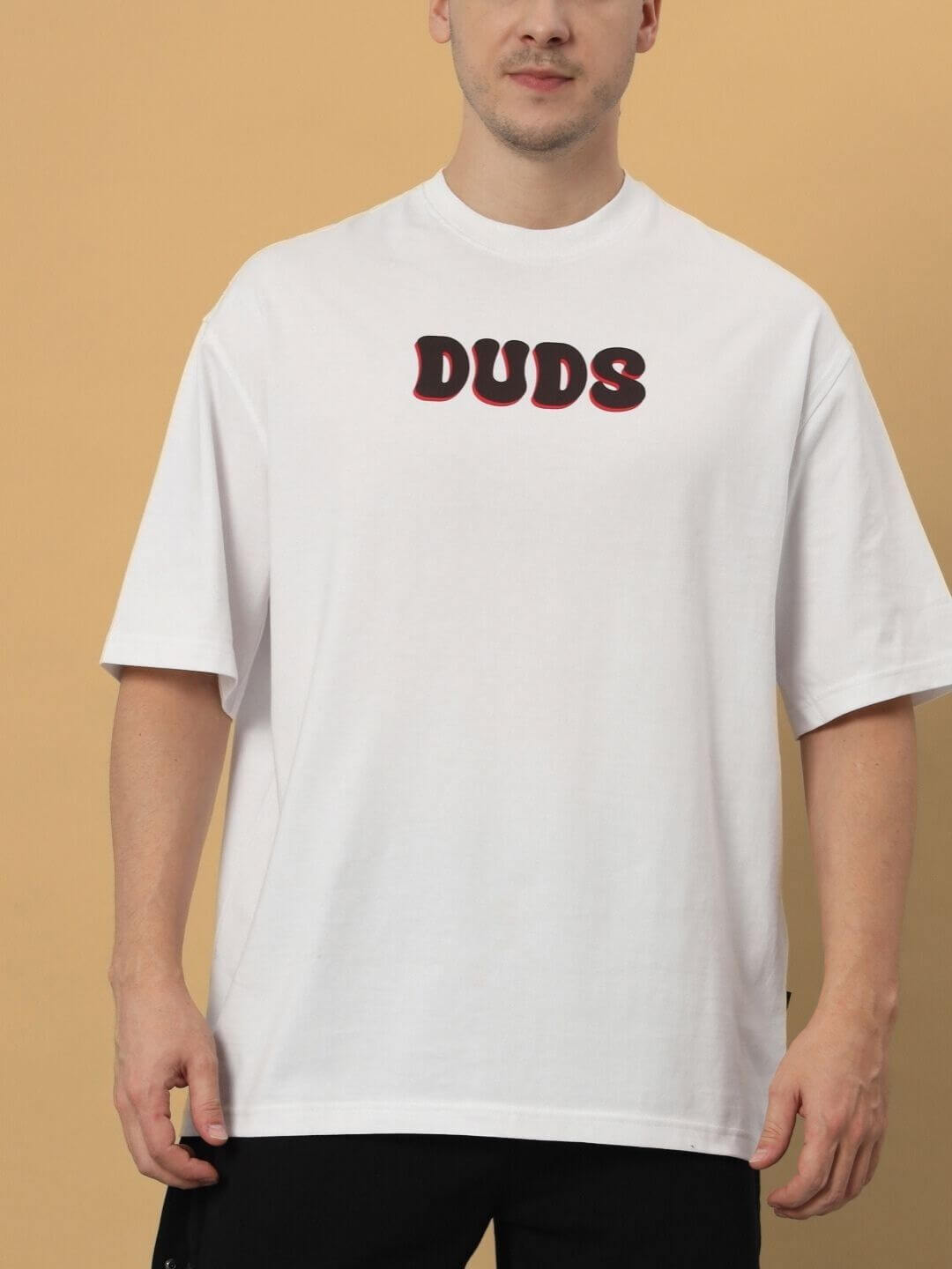 Man wearing CARINO OVER-SIZED T-SHIRT WHITE made of 100% cotton, with DUDS print, premium heavy gauge fabric.