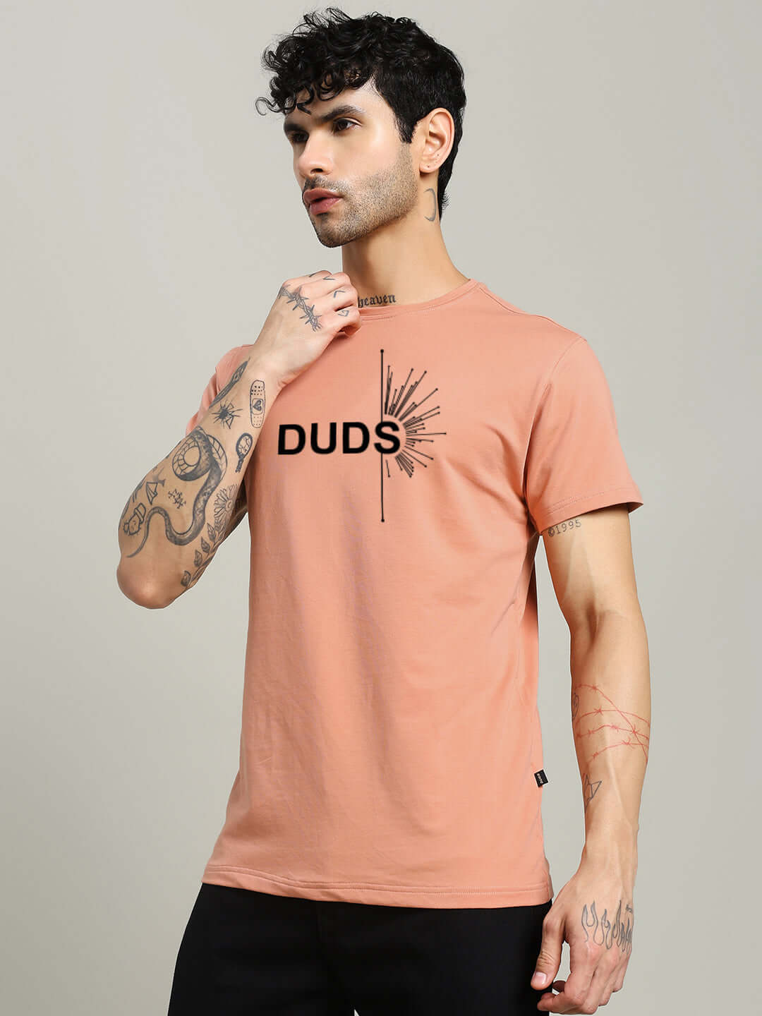 Man wearing peach Fallen Angle regular fit T-shirt made from 100% cotton, featuring "DUDS" print, by Color By Colours.