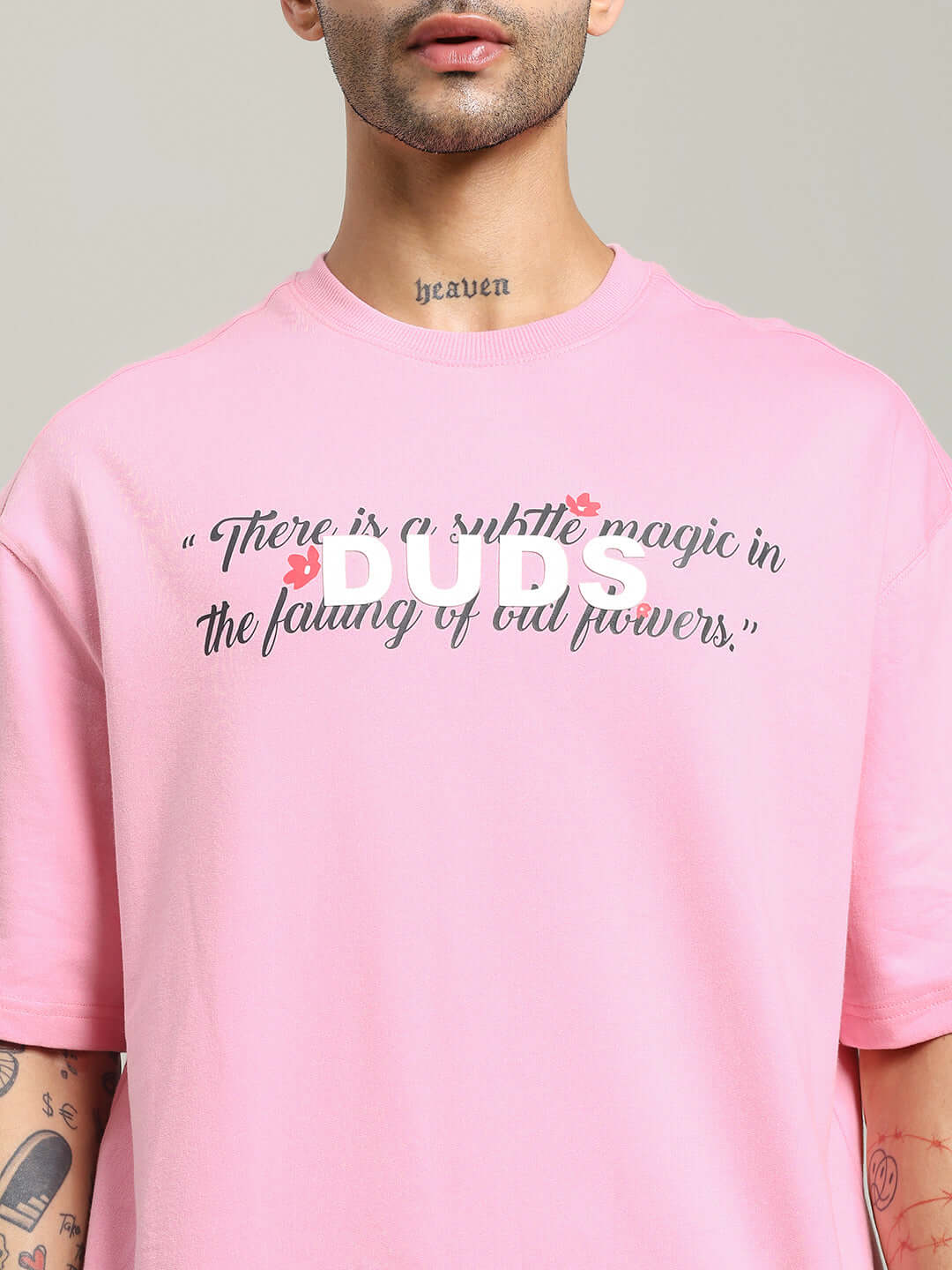 Close-up of person wearing FALLING FLOWER T-SHIRT PINK with printed quote on the front.