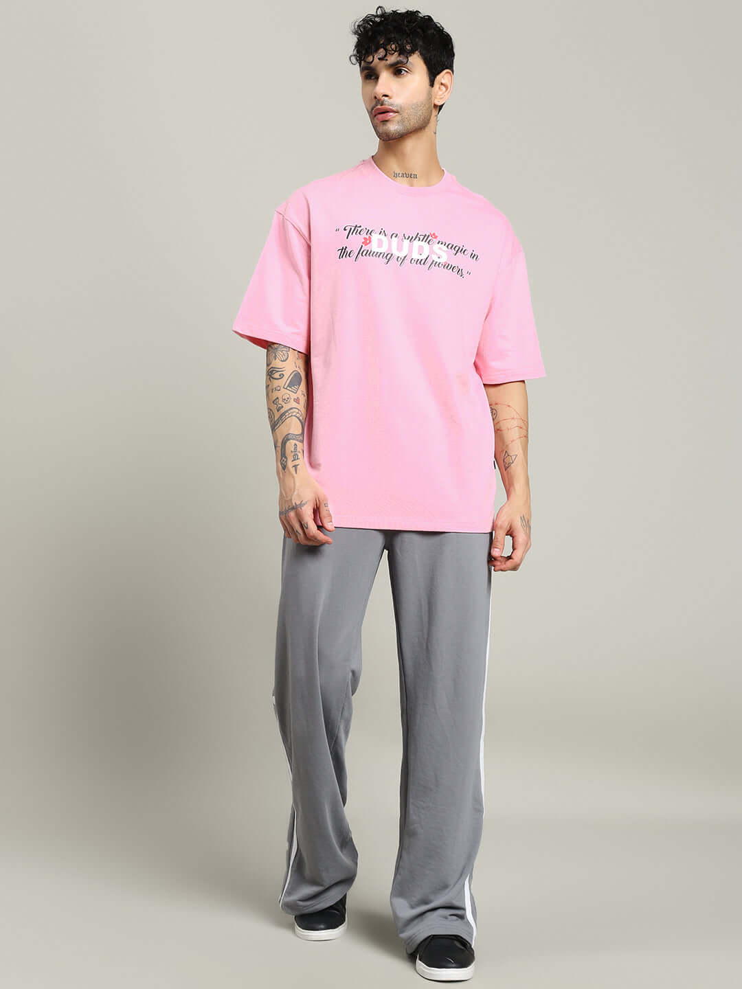 FALLING FLOWER T-SHIRT PINK modeled by a man wearing casual pants, showcasing the stylish and comfortable pink tee.
