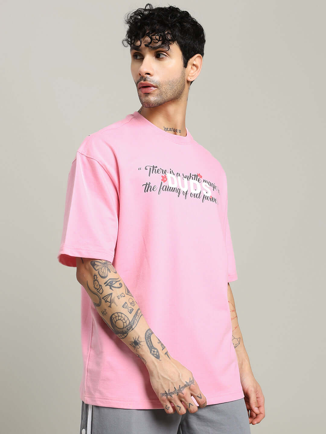 Man wearing FALLING FLOWER T-SHIRT PINK, crafted from premium cotton blend, showcasing casual elegance and comfort.