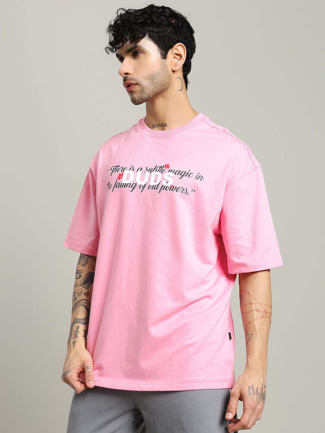 Model wearing a FALLING FLOWER T-SHIRT PINK, crafted from premium cotton blend, showcasing a regular fit for casual and elegant style.