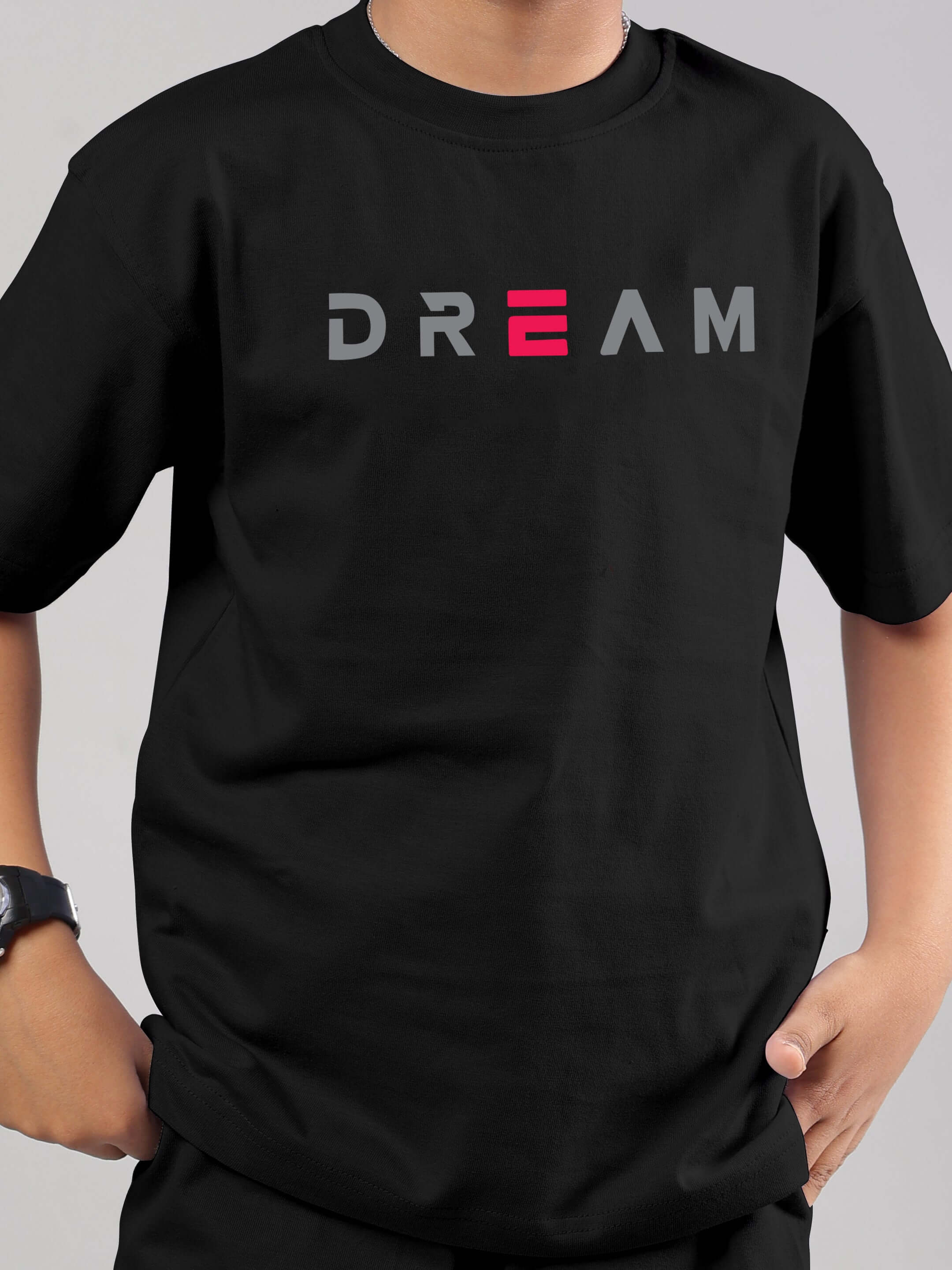 Child wearing black 'FANCY DREAM' co-ord by DUDS, hands in pockets, custom fit available.