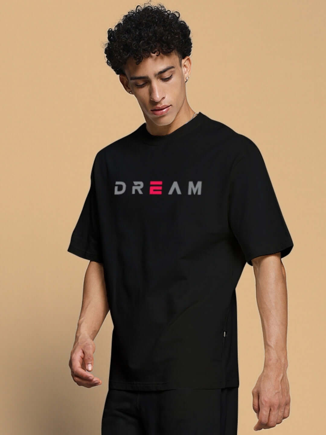 Man wearing Fancy Dream Over-Sized T-Shirt Black with 'DREAM' print.