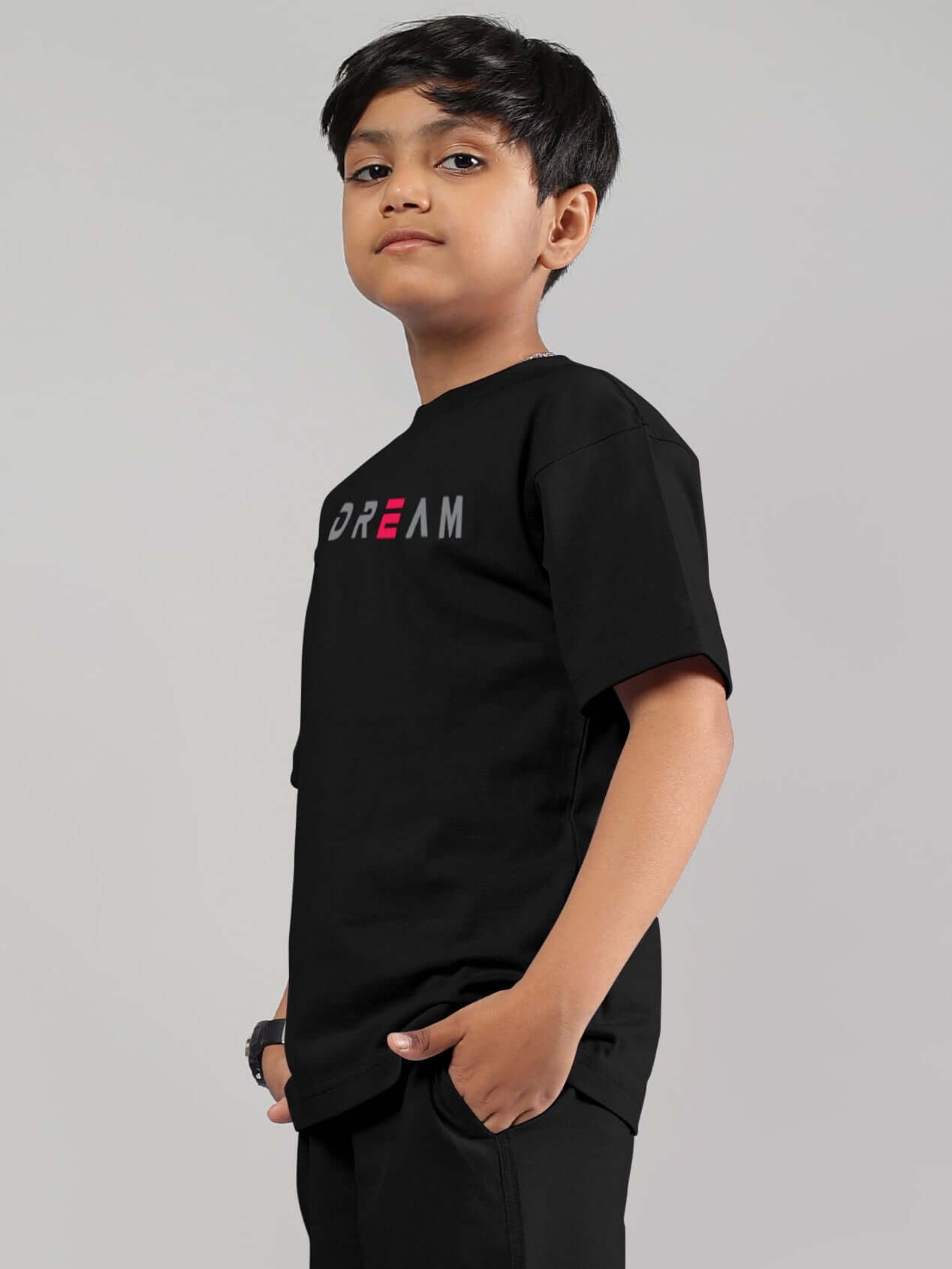 Boy wearing FANCY DREAM T-SHIRT FOR BOYS GIRLS BLACK showcasing modern unisex fit and style.