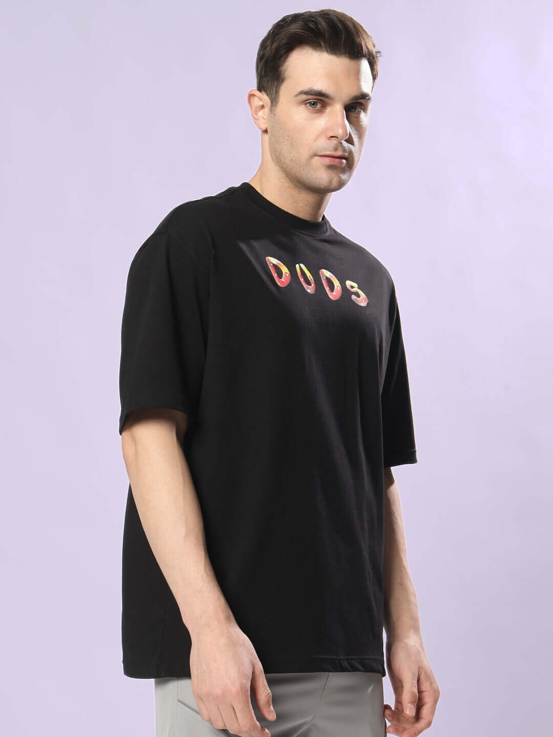 Model wearing black Fantasy Mushroom over-sized t-shirt with colorful 'DUDS' print on front