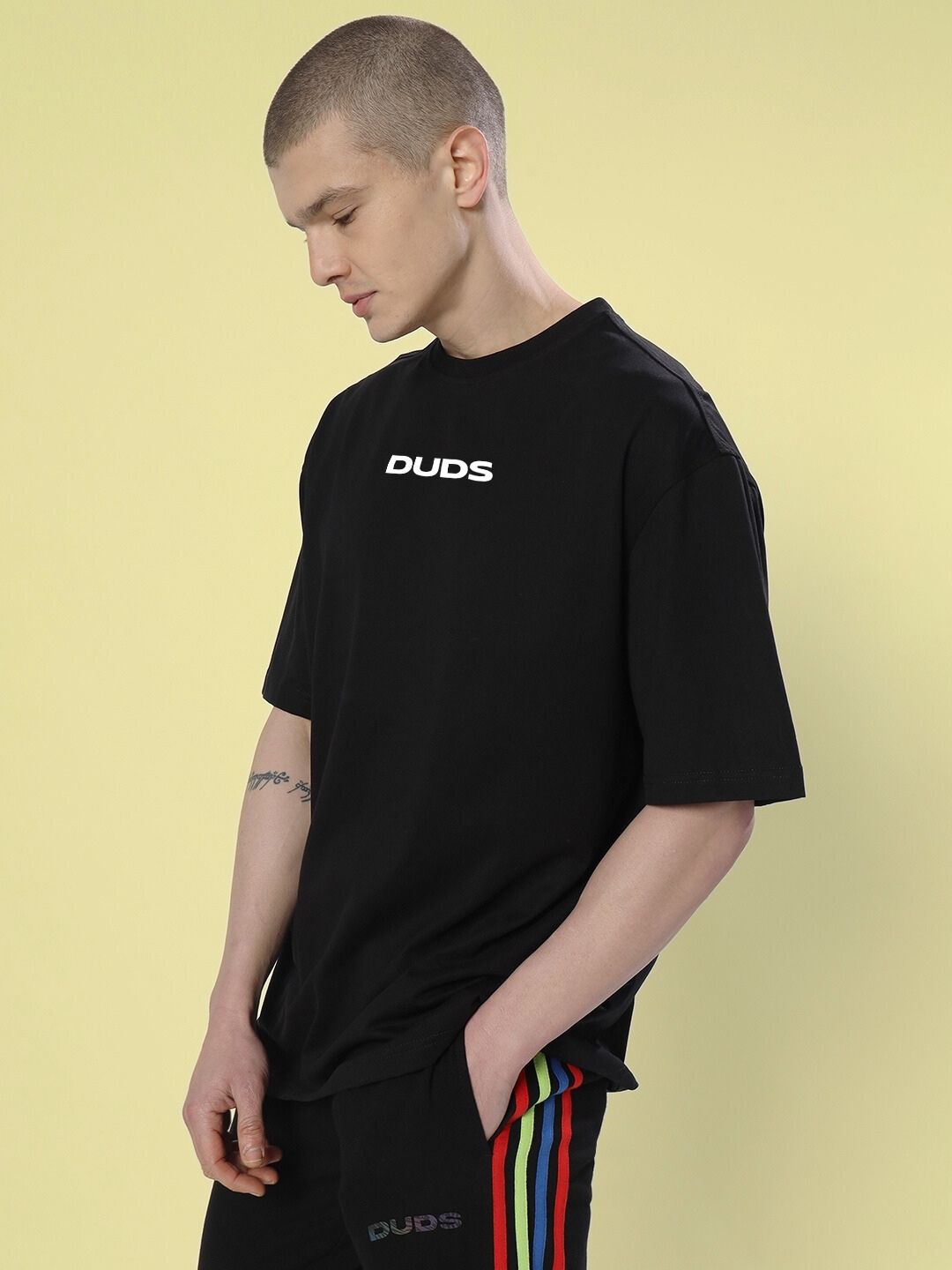 Model wearing FARARI PRINTED OVERSIZED T-SHIRT BLACK with logo, short sleeves, casual look.