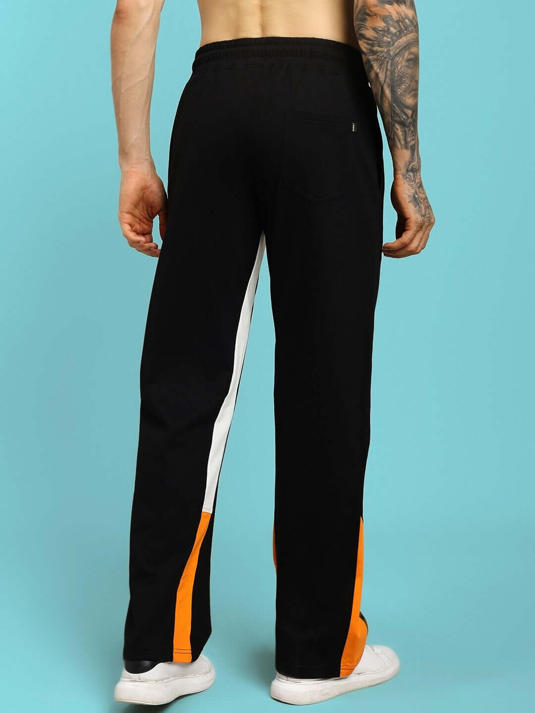 Back view of FEARLESS CONTRAST POSITIVE RELAXED FIT JOGGERS BLACK-ORANGE with bold side stripes.