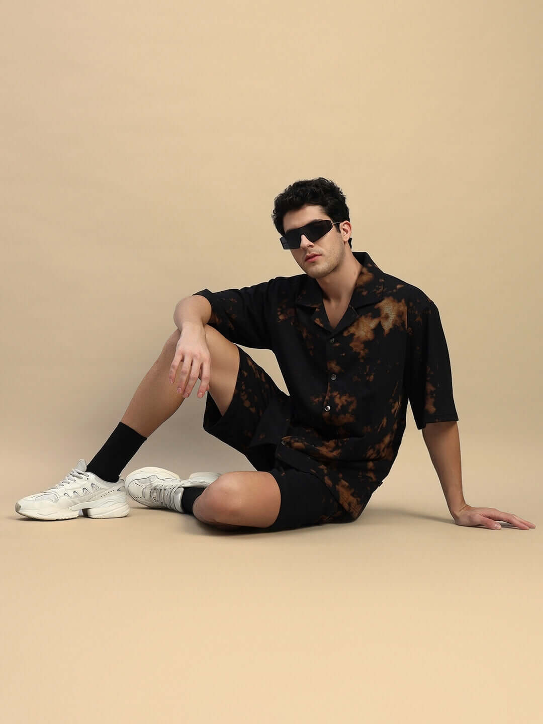 Model wearing FEEL GOOD tie-dye black co-ord set with sunglasses and sneakers, showcasing premium cotton terry fabric, India made.