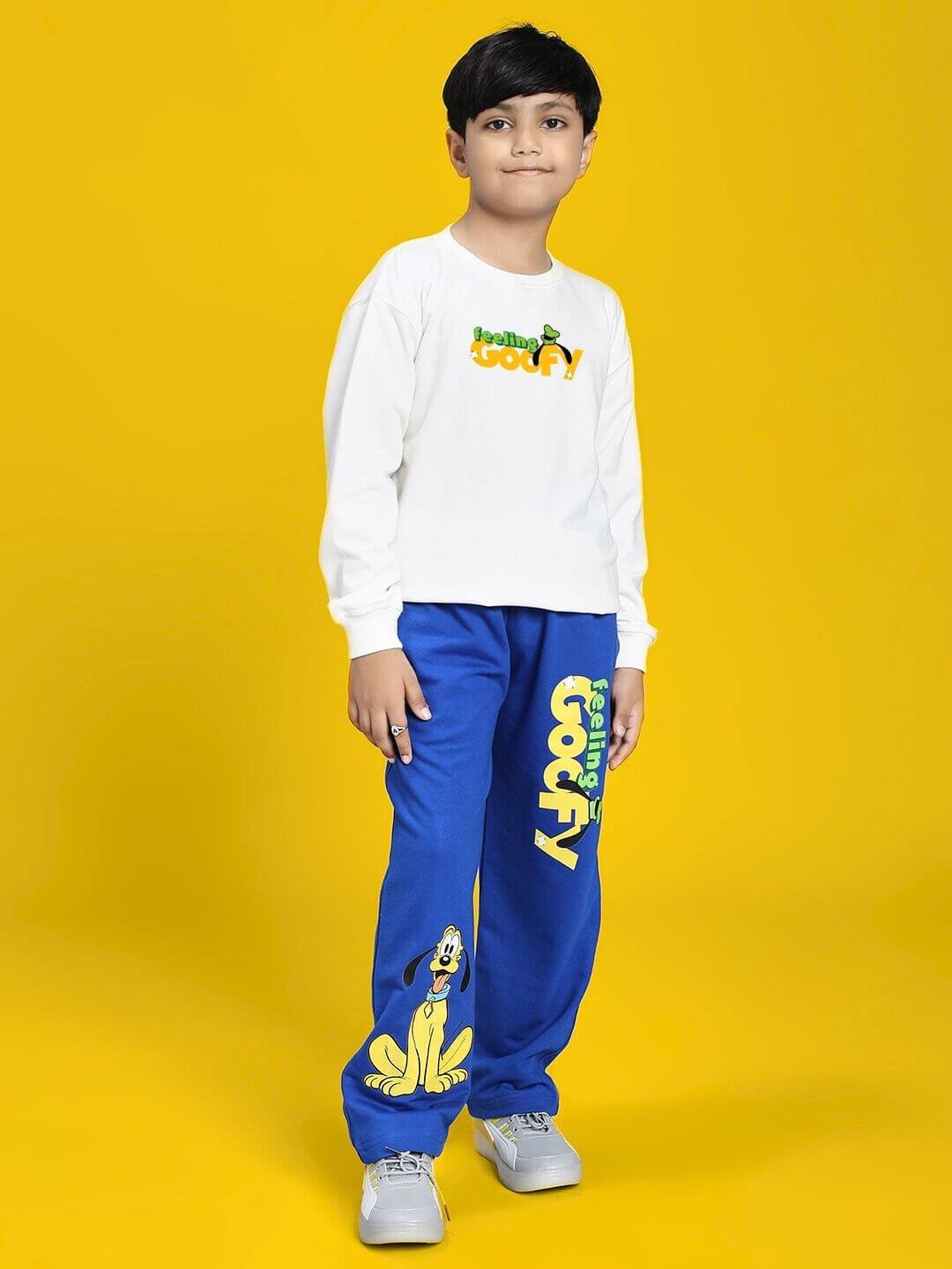 Child wearing FEELING GOOFY JOGGER FOR BOYS AND GIRLS BLUE with a cartoon character design on yellow background.