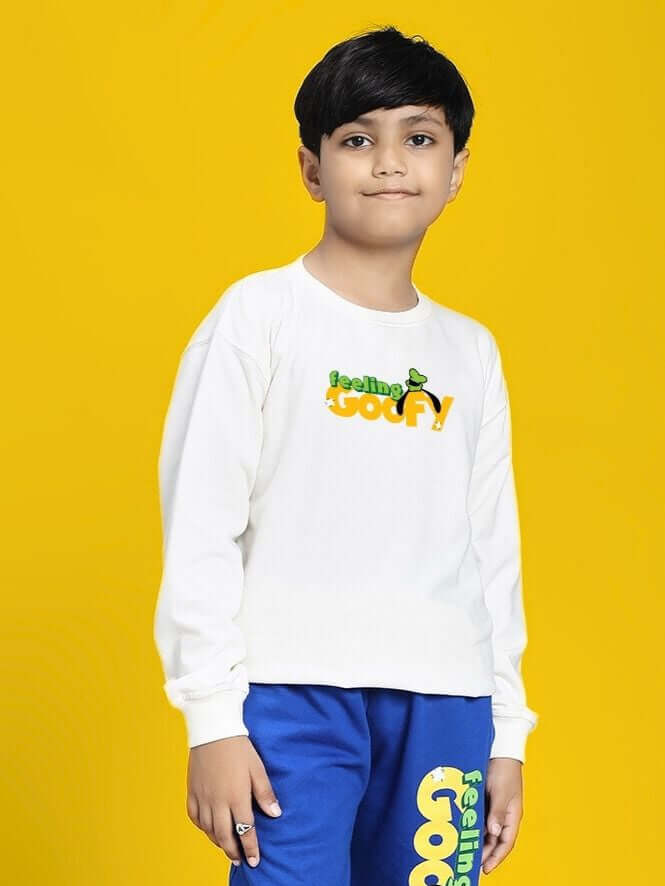 Young boy wearing FEELING GOOFY SWEATSHIRT FOR BOYS AND GIRLS WHITE against yellow background