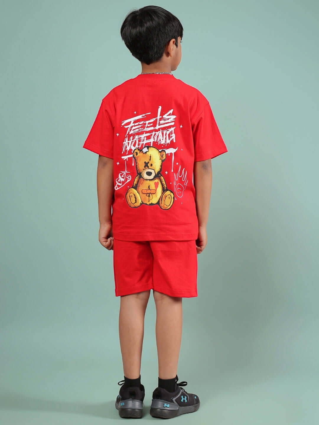 Child wearing FEELS NOTHING CO-ORD FOR BOYS & GIRLS RED featuring a teddy bear design on the back of the shirt, showcasing a vibrant look.