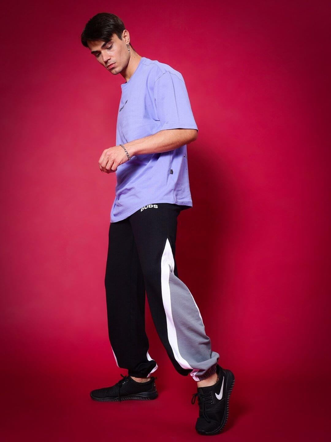 Model wearing BREATHE OVER-SIZED T-SHIRT PERIWINKLE against red background
