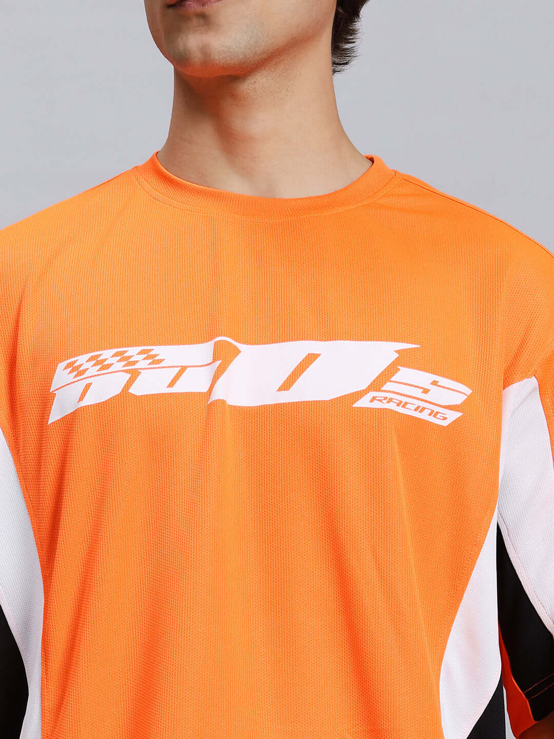 FIFA COLORBLOCK CO-ORD SET ORANGE sports polyester fabric with printed logo, close-up view.