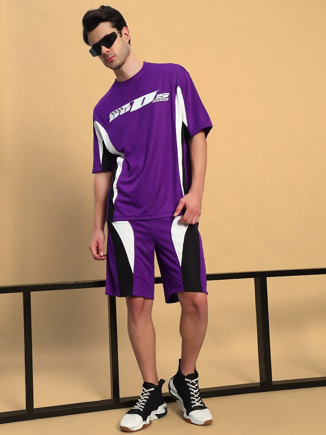 FIFA COLORBLOCK CO-ORD SET PURPLE unisex sportswear outfit featuring a relaxed-fit t-shirt and shorts, modeled in a sporty stance.