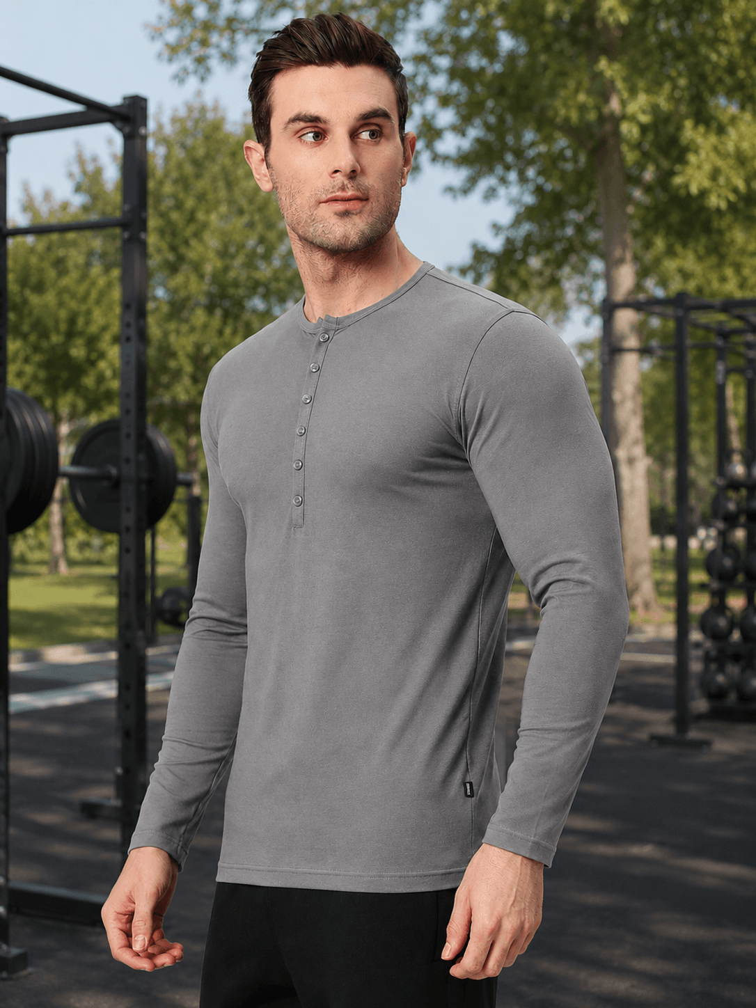 HENNY SLIM FIT SWEATSHIRT GREY worn by a man in a fitness setting, showcasing a sleek and modern design.