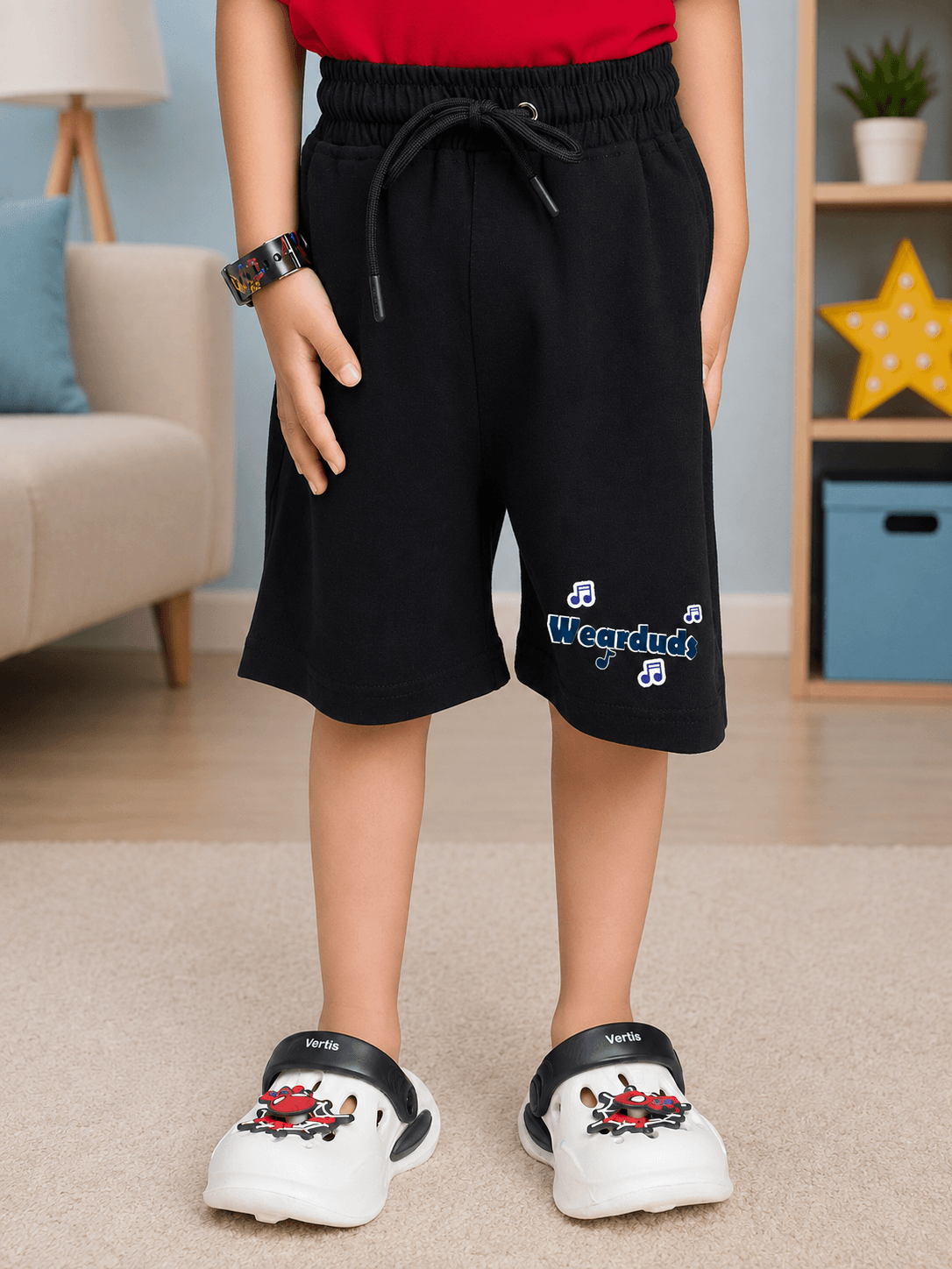 LITTLE ROCKSTAR SHORTS FOR BOYS GIRLS BLACK displayed on a child, showcasing a stylish and comfortable design.