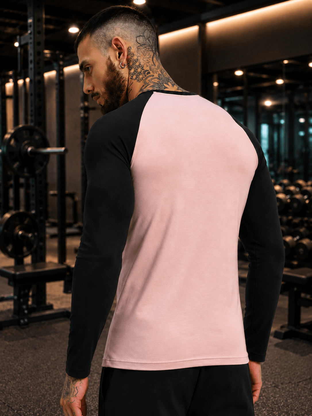 FITFLOW SLIM FIT SWEATSHIRT PINK BLACK worn by a man in a gym setting, showcasing its stylish design and color contrast.