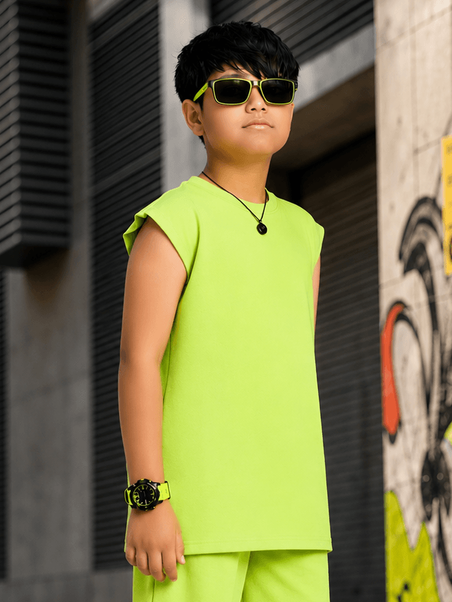 NEON RUSH SLEEVELESS T-SHIRT FOR BOYS GIRLS NEON GREEN worn by a confident child with stylish accessories.