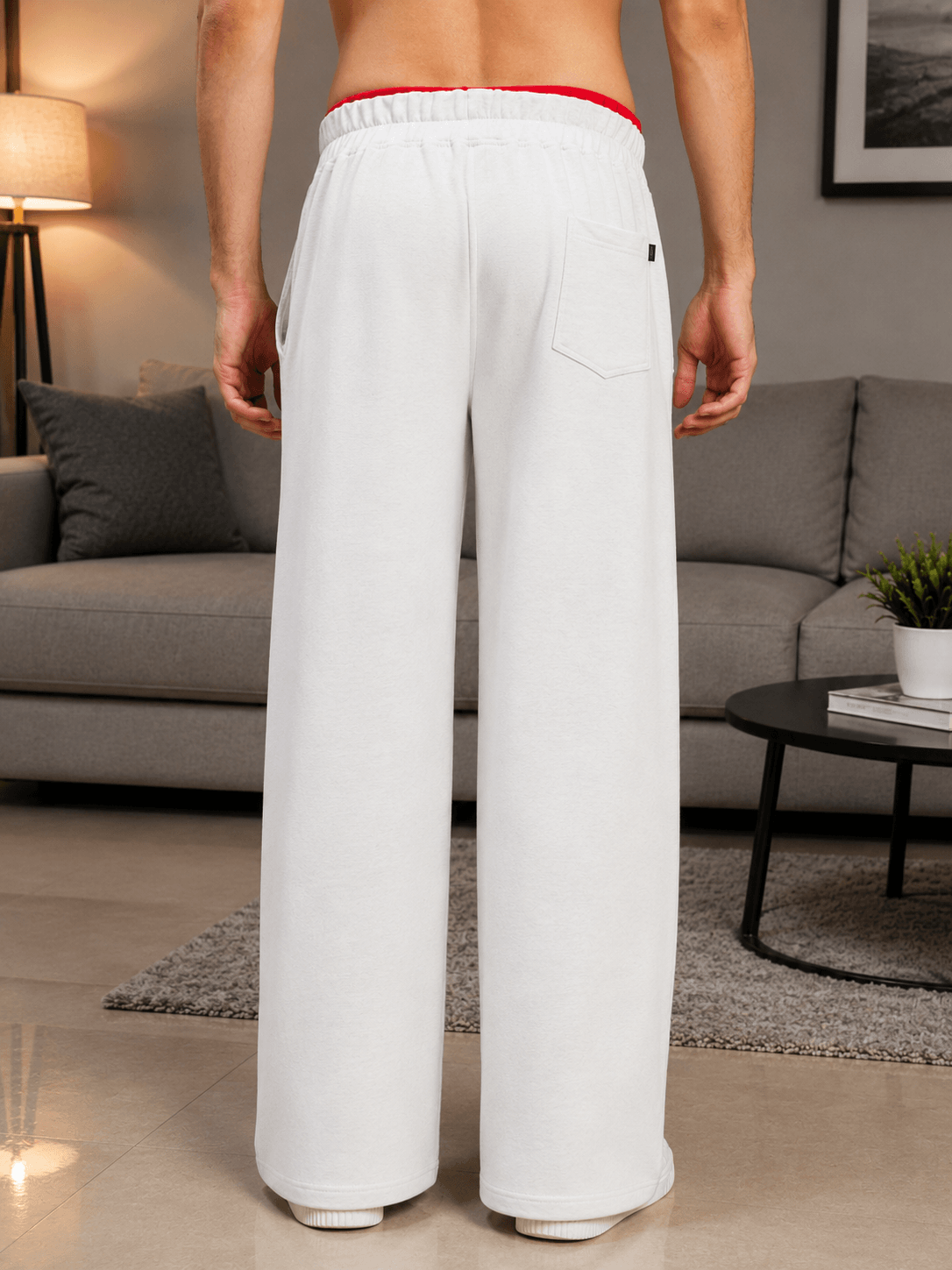 Man wearing SNOW STREETWEAR BAGGY JOGGERS MELANGE GREY from the back, showcasing relaxed urban style.