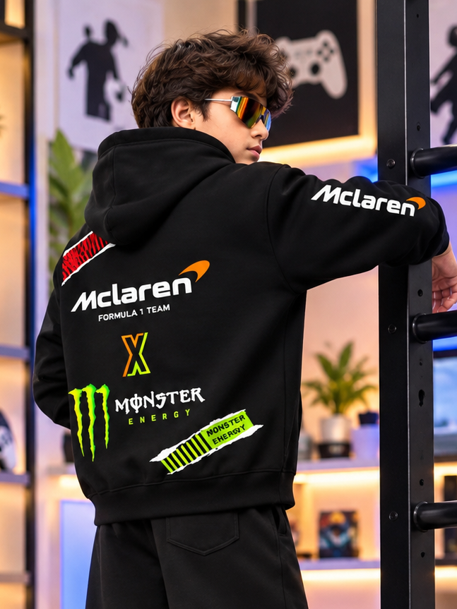 MONSTER DRINK FLEECE HOODIE FOR KIDS BLACK with McLaren Formula 1 Team graphics, worn by a boy in sunglasses