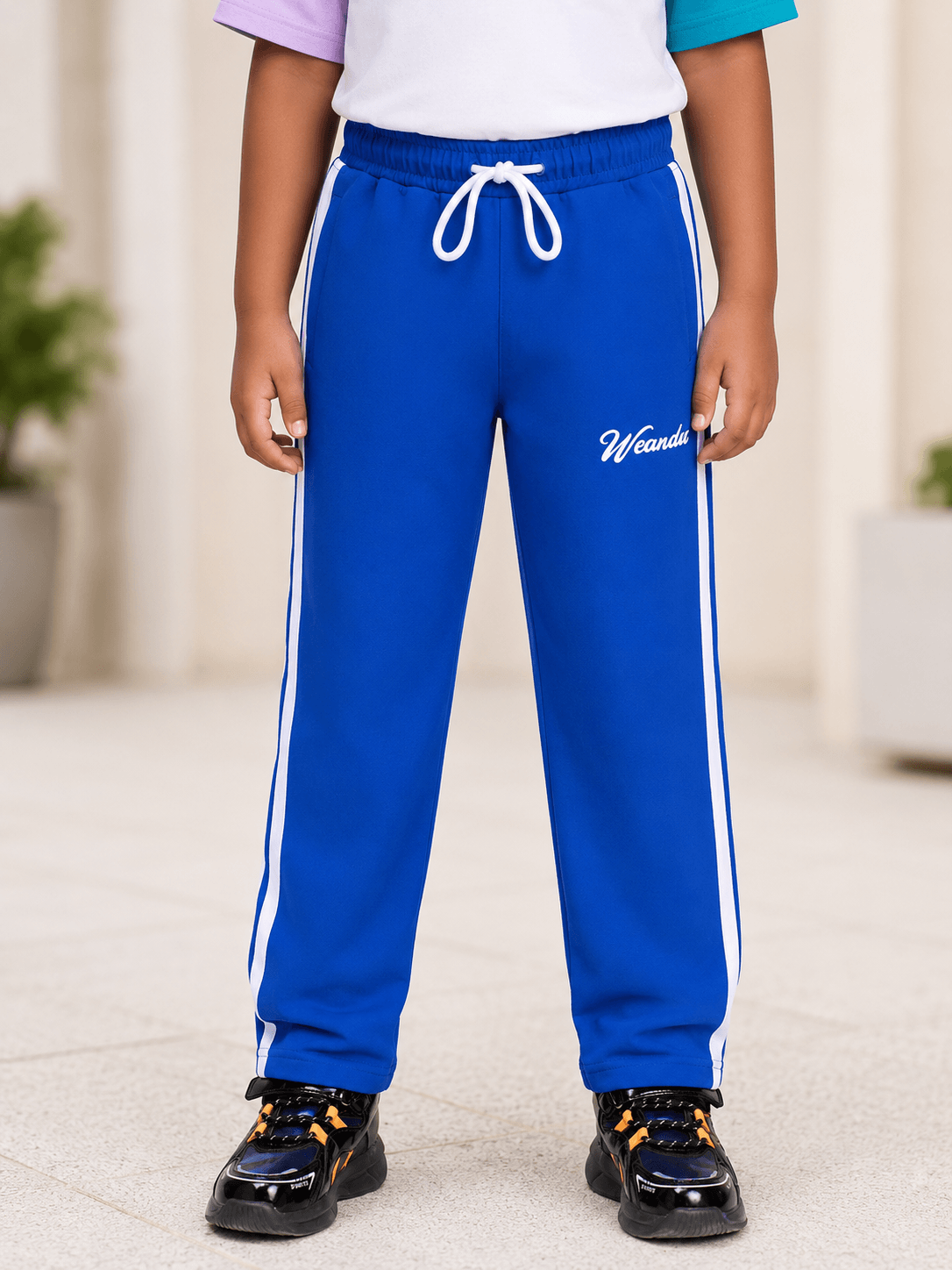 SPORTY STRIPE JOGGER FOR BOYS AND GIRLS ROYAL BLUE with stylish stripes, perfect for kids' active wear.