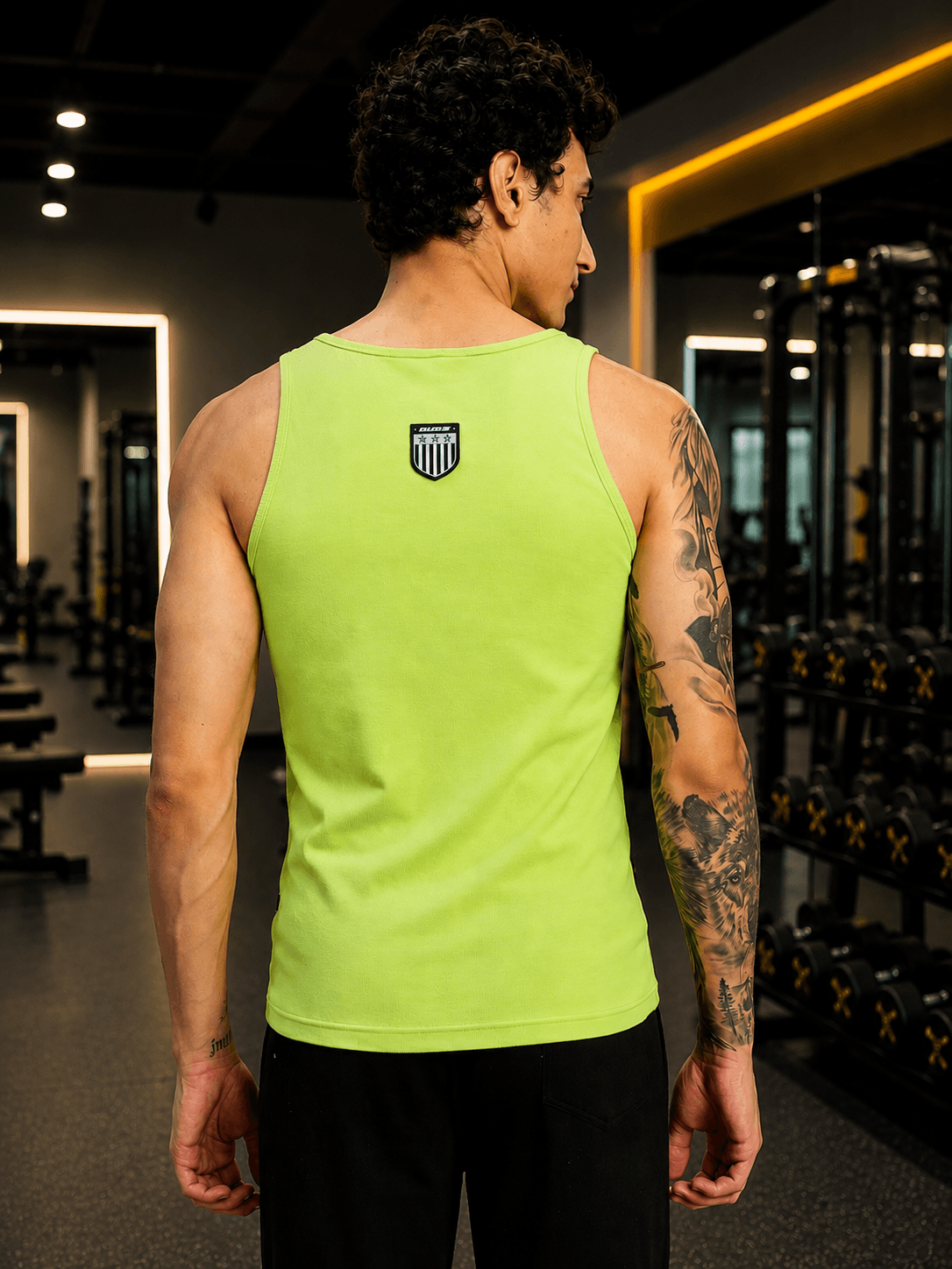 EASY WEAR VEST GYM T-SHIRT NEON GREEN worn by man showing back with gym equipment in the background.