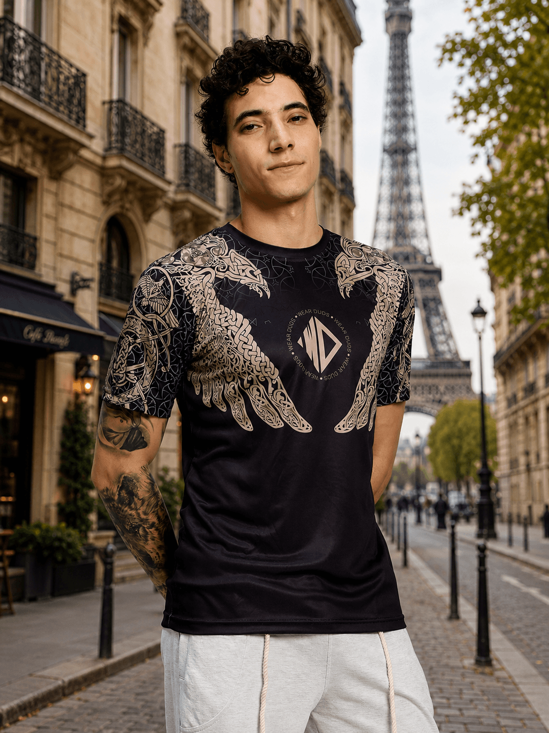 AURA OF ASGARD REGULAR T-SHIRT BLACK showcased on a model in front of the Eiffel Tower in Paris.