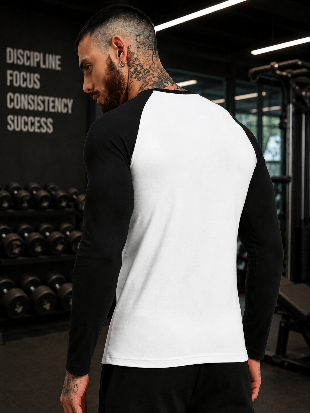 FITFLOW SLIM FIT SWEATSHIRT WHITE BLACK worn by a man in a gym setting showcasing its sleek design.