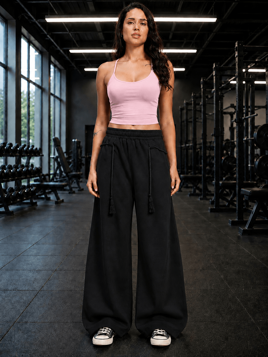 Women Seamless Cotton Crop-Top Pink worn with black wide-leg pants in a gym setting.