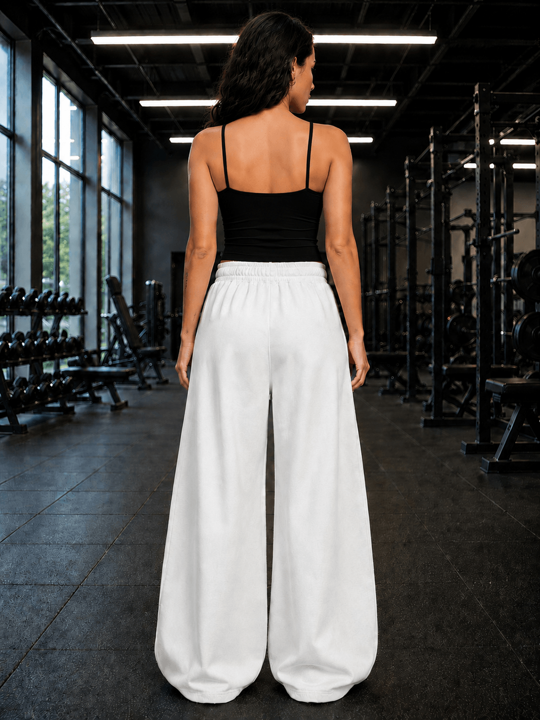 WOMEN SEAMLESS COTTON CROP-TOP BLACK styled with wide white pants in a gym setting.