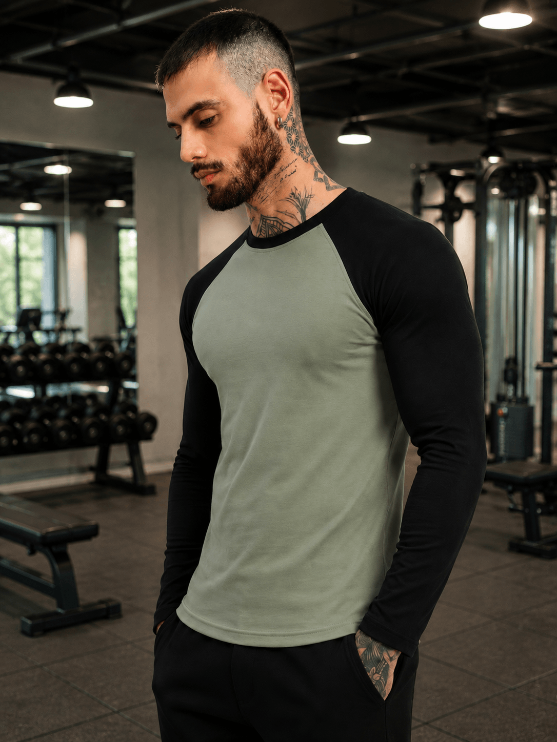 FITFLOW SLIM FIT SWEATSHIRT SAGE GREEN BLACK worn by a man in a gym setting with weights in the background.