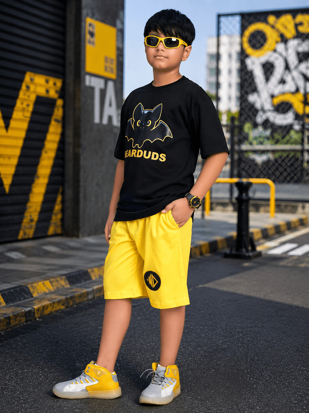 MIDNIGHT BAT CO-ORD FOR BOYS GIRLS BLACK YELLOW worn by a boy in a trendy urban setting.