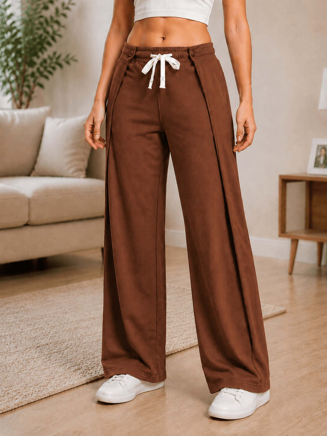 WOMEN OMEGA FLOW WIDE FIT JOGGERS DARK BROWN modeled in a stylish setting, showcasing relaxed silhouette and comfort.