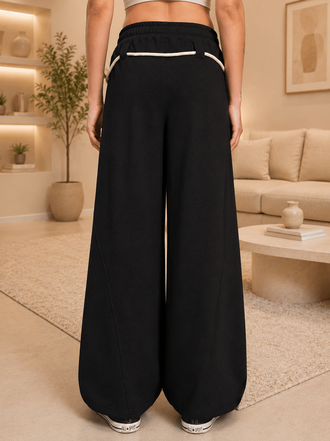 WOMEN COOLFIT BAGGY LOOSE FIT JOGGER BLACK - Back view showing relaxed fit design in a cozy indoor setting.