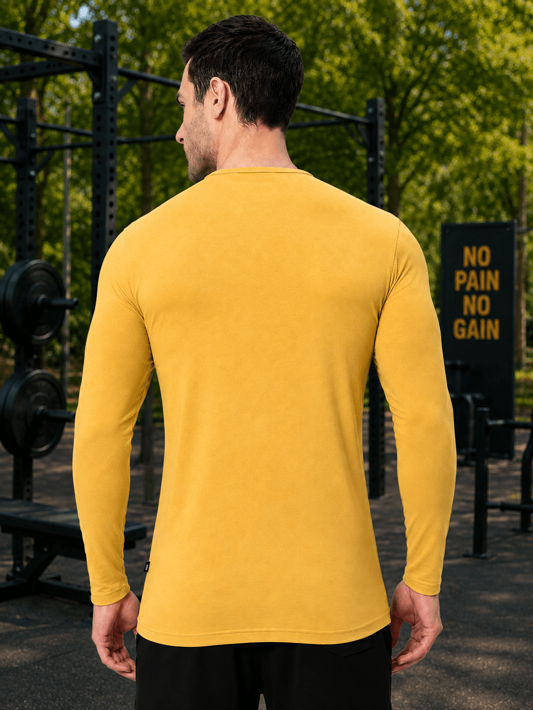 Man wearing HENNY SLIM FIT SWEATSHIRT YELLOW in a gym setting, showcasing the sleek design and comfortable fit.