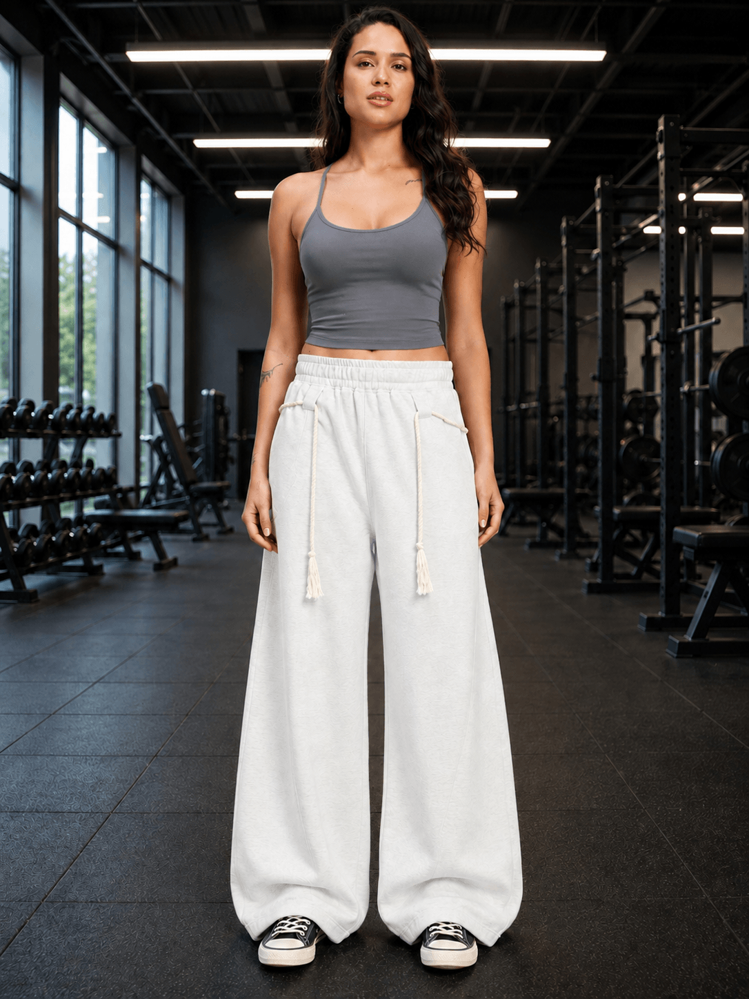 Women Seamless Cotton Crop-Top Grey styled with wide-leg pants in a gym setting, highlighting comfort and modern style.
