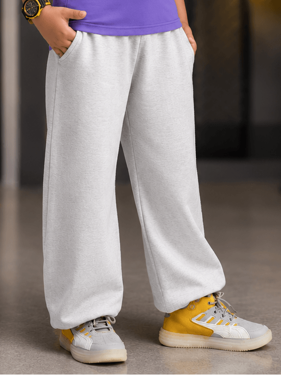 COOLFIT JOGGER FOR BOYS GIRLS WHITE featuring a child in comfortable grey joggers with pockets.