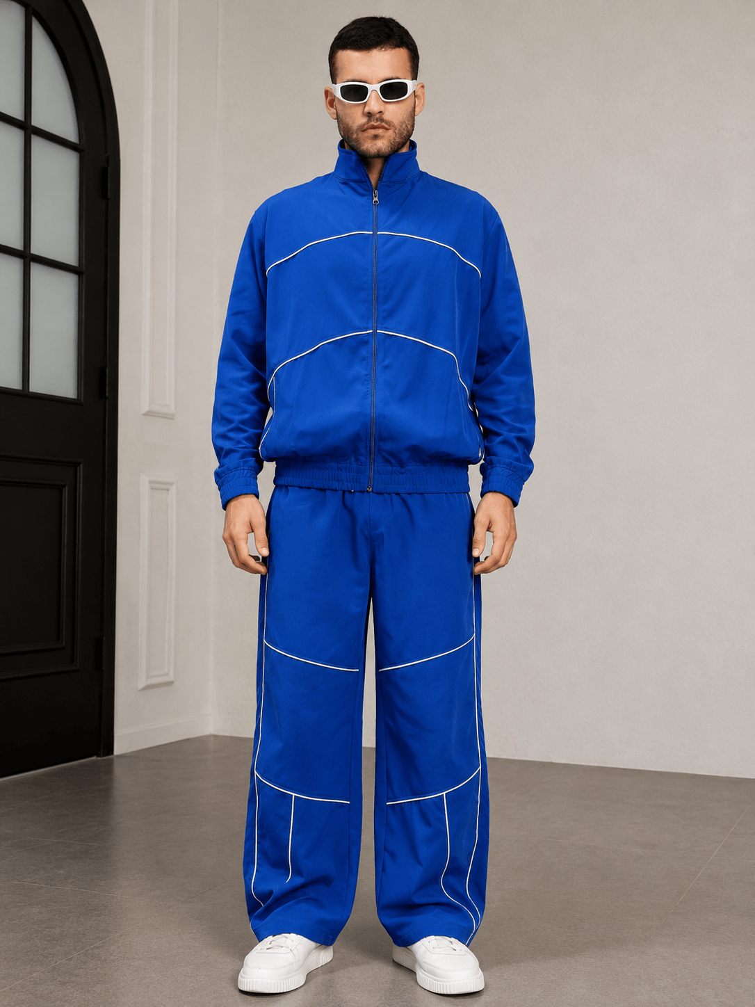 RAIDER CO-ORD SET BLUE WITH WHITE ACCENTS worn by a model, showcasing a sporty and contemporary style.