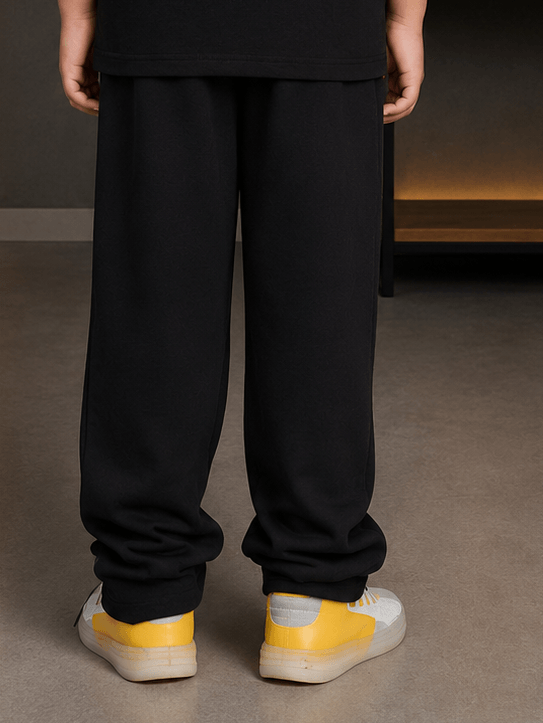 YOUTH CONTREST PIPING JOGGER FOR BOYS GIRLS OLIVE GREEN shown from behind, paired with yellow sneakers.