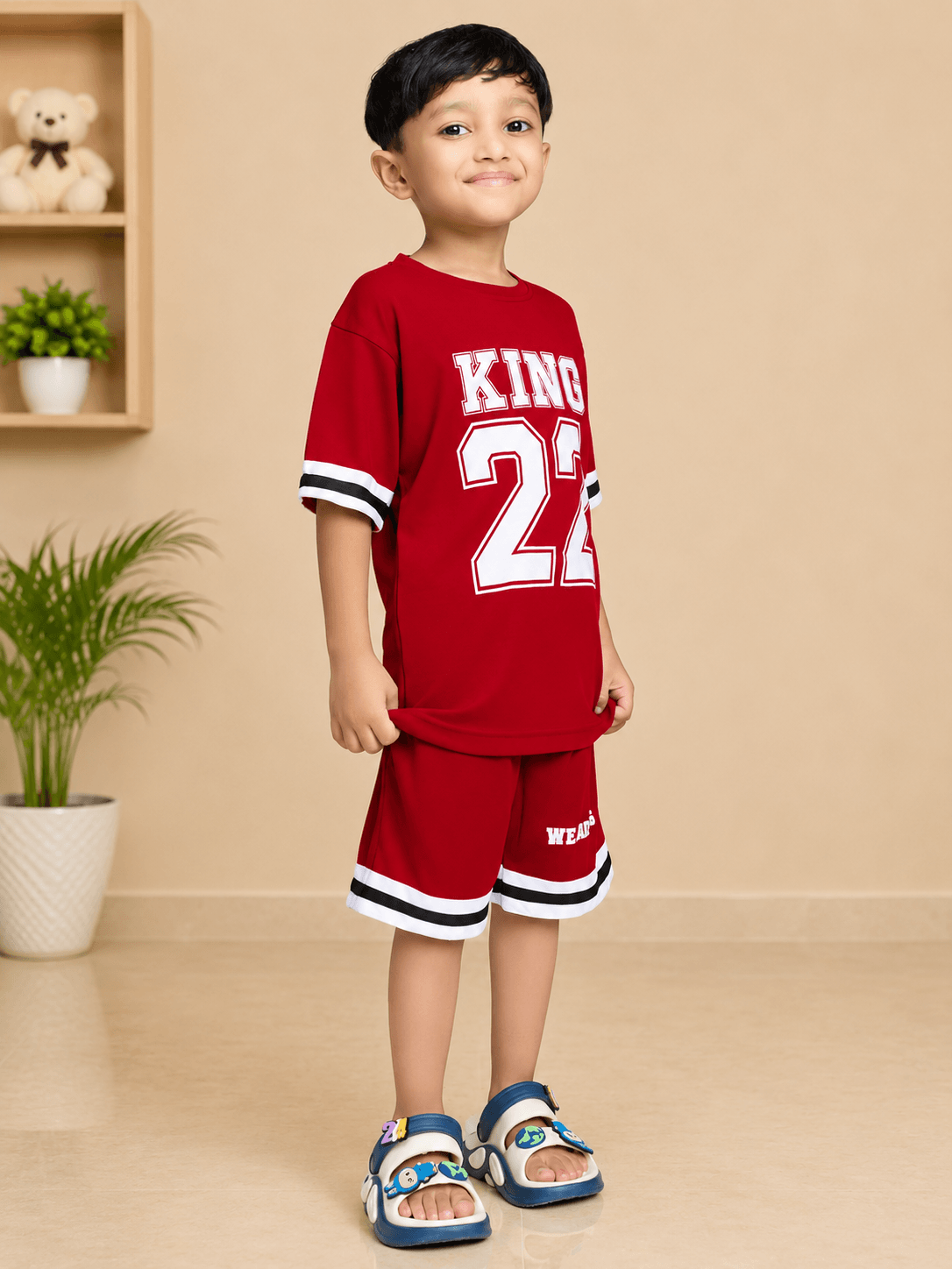 KING 22 VARSITY CO-ORD SET FOR BOYS GIRLS RED worn by a boy, showcasing vibrant color and sporty design.