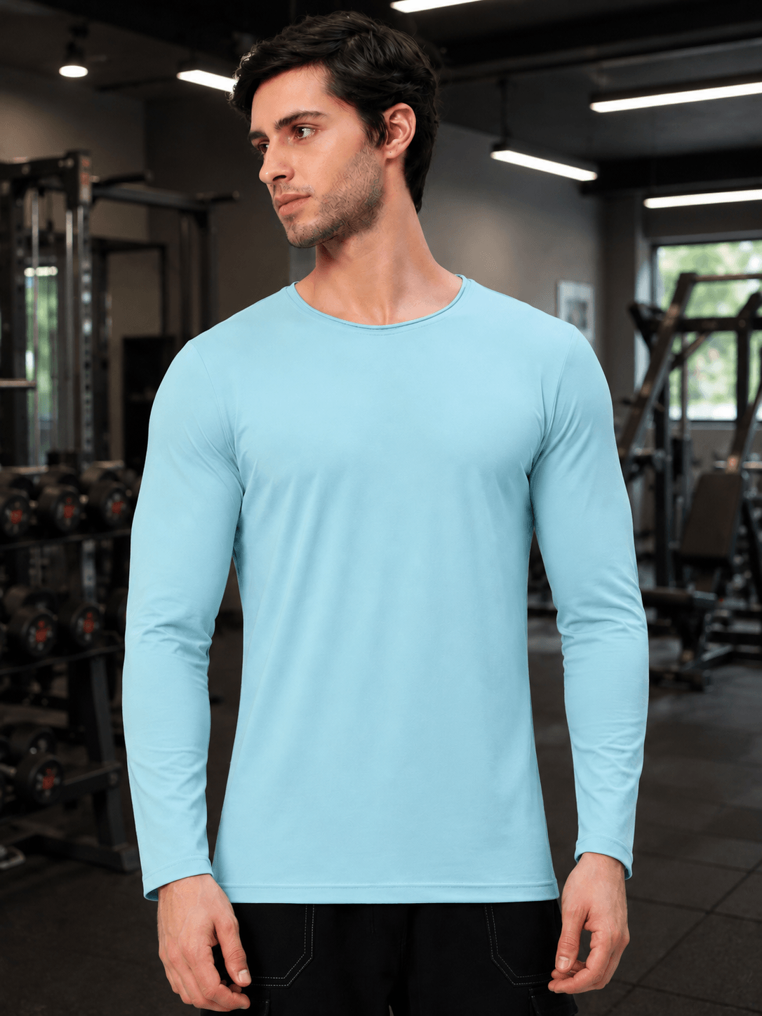 OMNI SLIM FIT SWEATSHIRT SKY BLUE worn by a model in a gym setting, showcasing its sleek design.