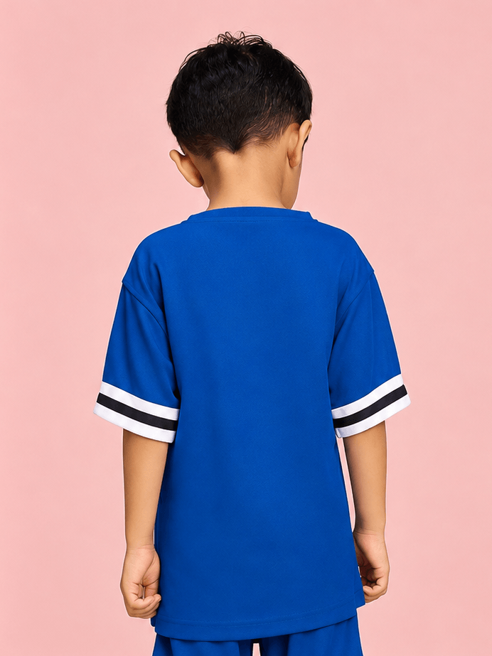 KING 22 VARSITY T-SHIRT FOR BOYS GIRLS BLUE worn by a child, showcasing its sporty blue design and stylish striped sleeves.