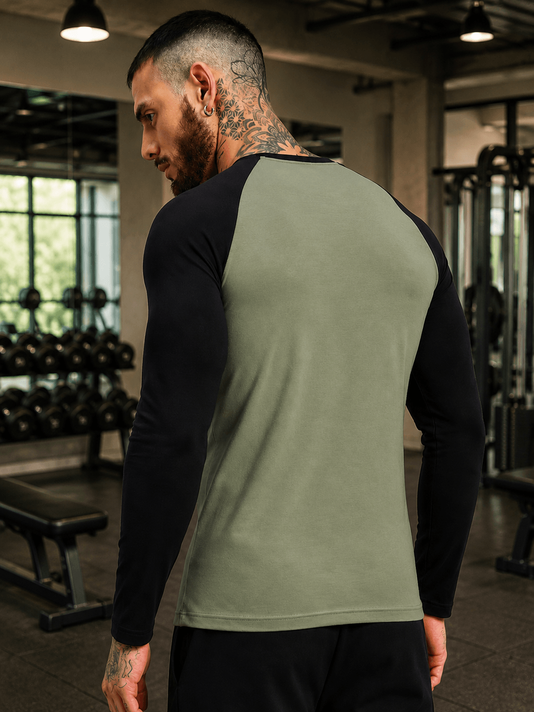 FITFLOW SLIM FIT SWEATSHIRT SAGE GREEN BLACK worn by model in gym setting showcasing sleek design.